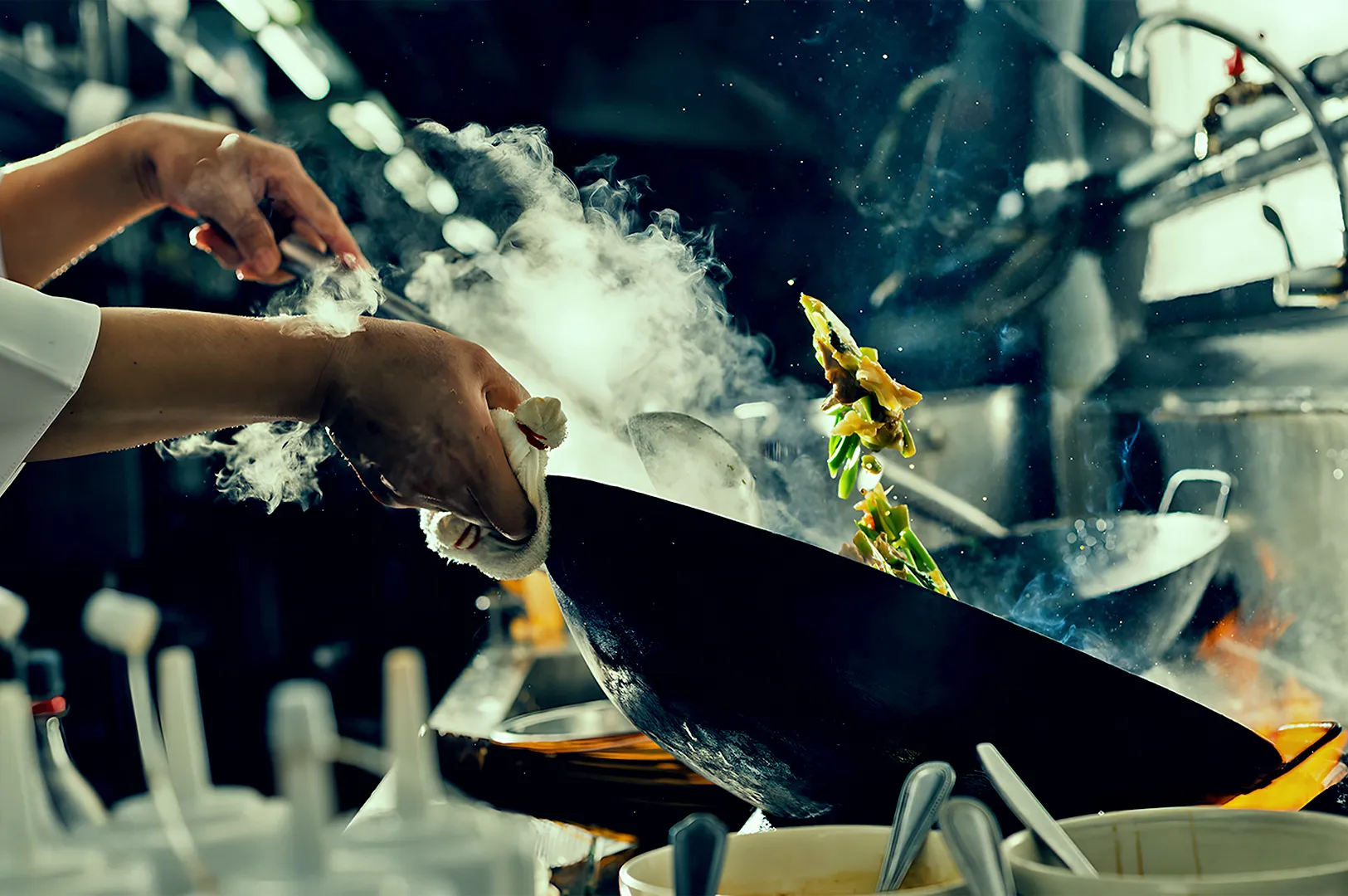 Chef expertly tosses vegetables in a steaming wok on a stove, surrounded by blurred kitchen background. Dynamic and energetic cooking scene.